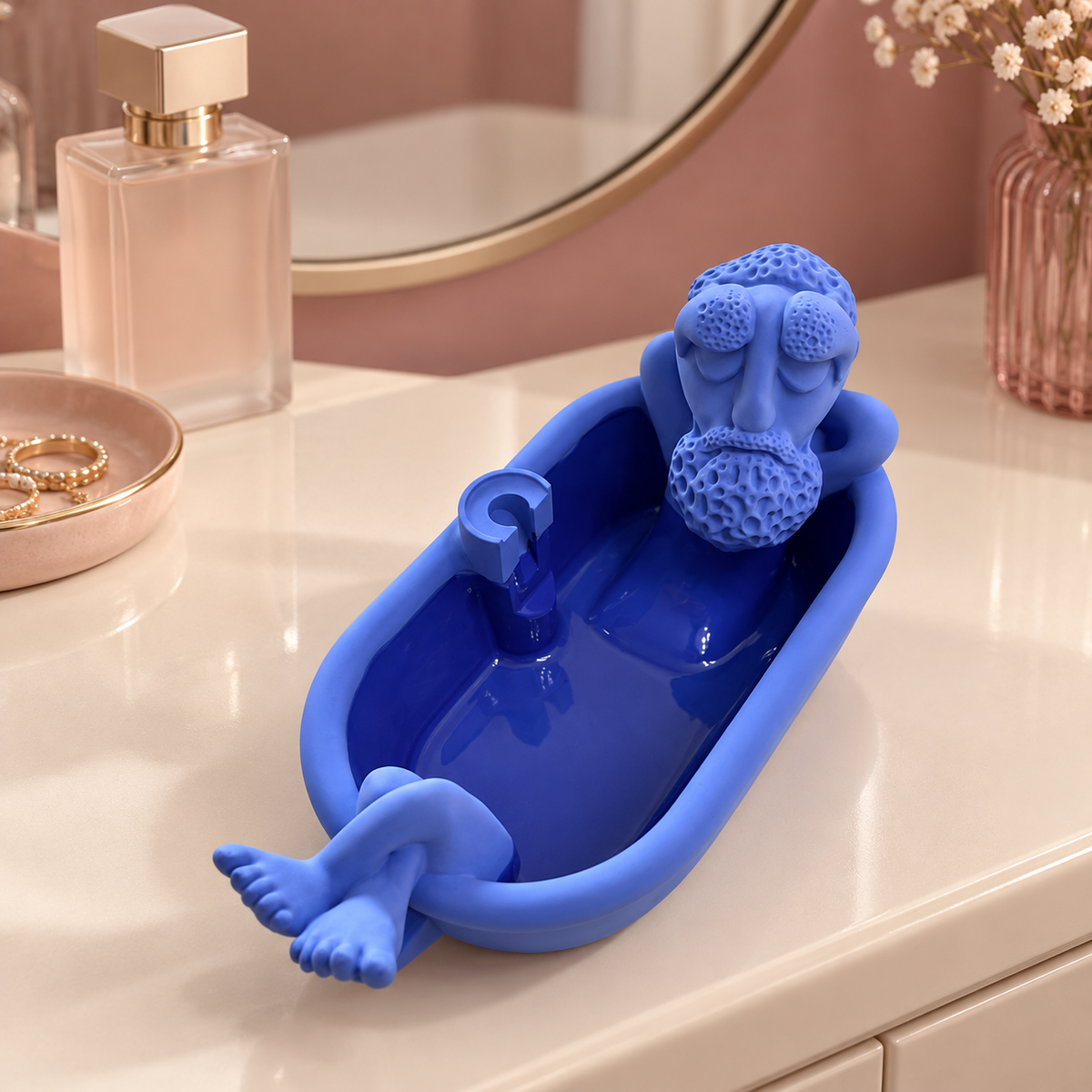 Blue bathtub-shaped grandpa incense burner on a vanity, empty cone holder visible.
